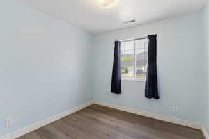 Empty room with baseboards and light wood finished floors