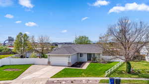 Single story home with a garage, concrete driveway, and a shingled roof