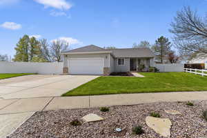Ranch-style home with covered porch, an attached garage, concrete driveway, and brick siding