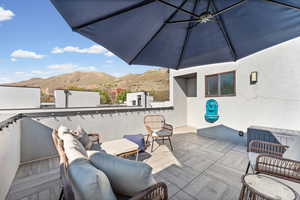 View of patio with a mountain view and an outdoor lounge area