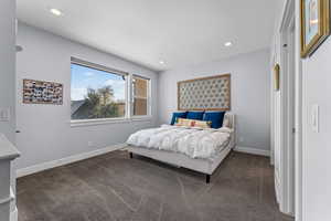 Carpeted bedroom with baseboards and recessed lighting