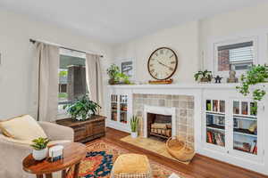 Living room with wood finished floors and a fireplace