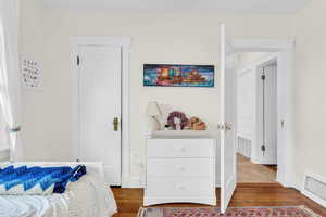 Bedroom with wood finished floors and baseboards