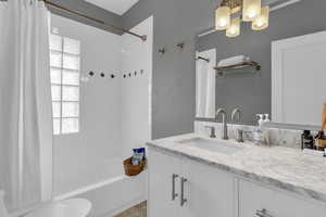 Full bathroom with vanity and shower / bath combo with shower curtain