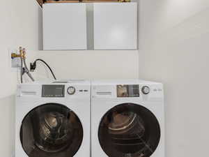Laundry area featuring washing machine and clothes dryer which are INCLUDED