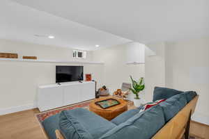 Living room featuring light wood-type flooring and recessed lighting