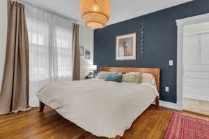 Bedroom featuring hardwood / wood-style floors and baseboards