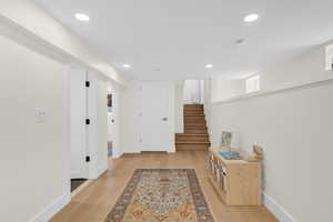 Corridor featuring light wood-style flooring, recessed lighting, and healthy amount of natural light
