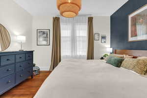 Bedroom with wood finished floors and baseboards