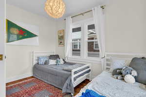 Bedroom featuring baseboards and wood finished floors