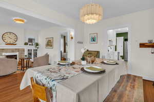 Dining room with dark wood-type flooring and a fireplace