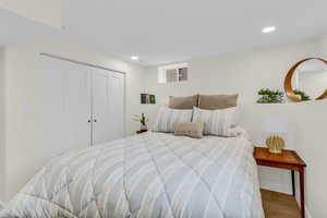 Bedroom featuring a closet, recessed lighting, and wood finished floors