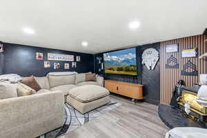 Living area featuring light wood-type flooring and recessed lighting