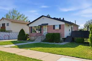 Bungalow-style home featuring a front lawn and brick siding