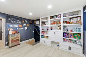 Recreation room featuring light wood-type flooring