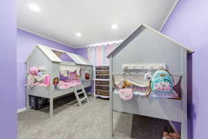 Bedroom with ornamental molding, light carpet, and recessed lighting