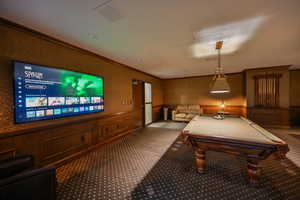 Community recreation room with pool tables, tv's and seating for entertaining.