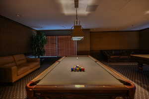 Community recreation room with pool tables, tv's and seating for entertaining.