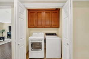 ***IN UNIT*** Laundry area with cabinet space, washing machine and dryer.