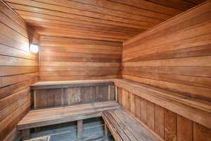 Relaxing sauna featuring wood walls and wood ceiling.