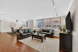 Living/formal dining area, East facing windows, natural light, hardwood flooring.