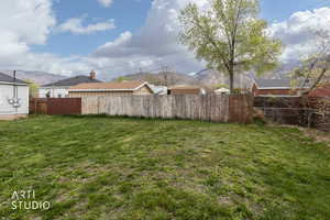 Fenced backyard featuring a mountain view