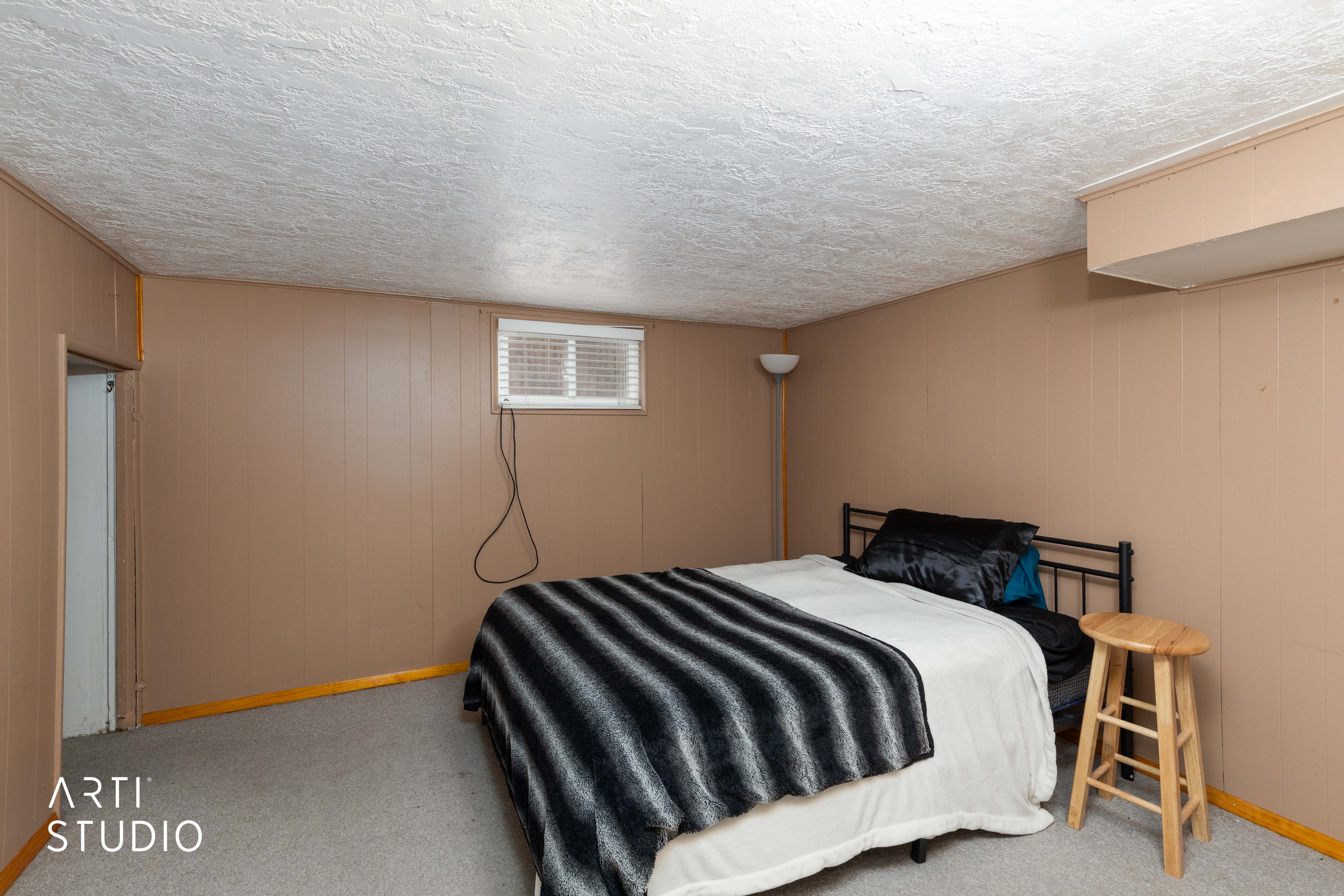 Bedroom with carpet and a textured ceiling
