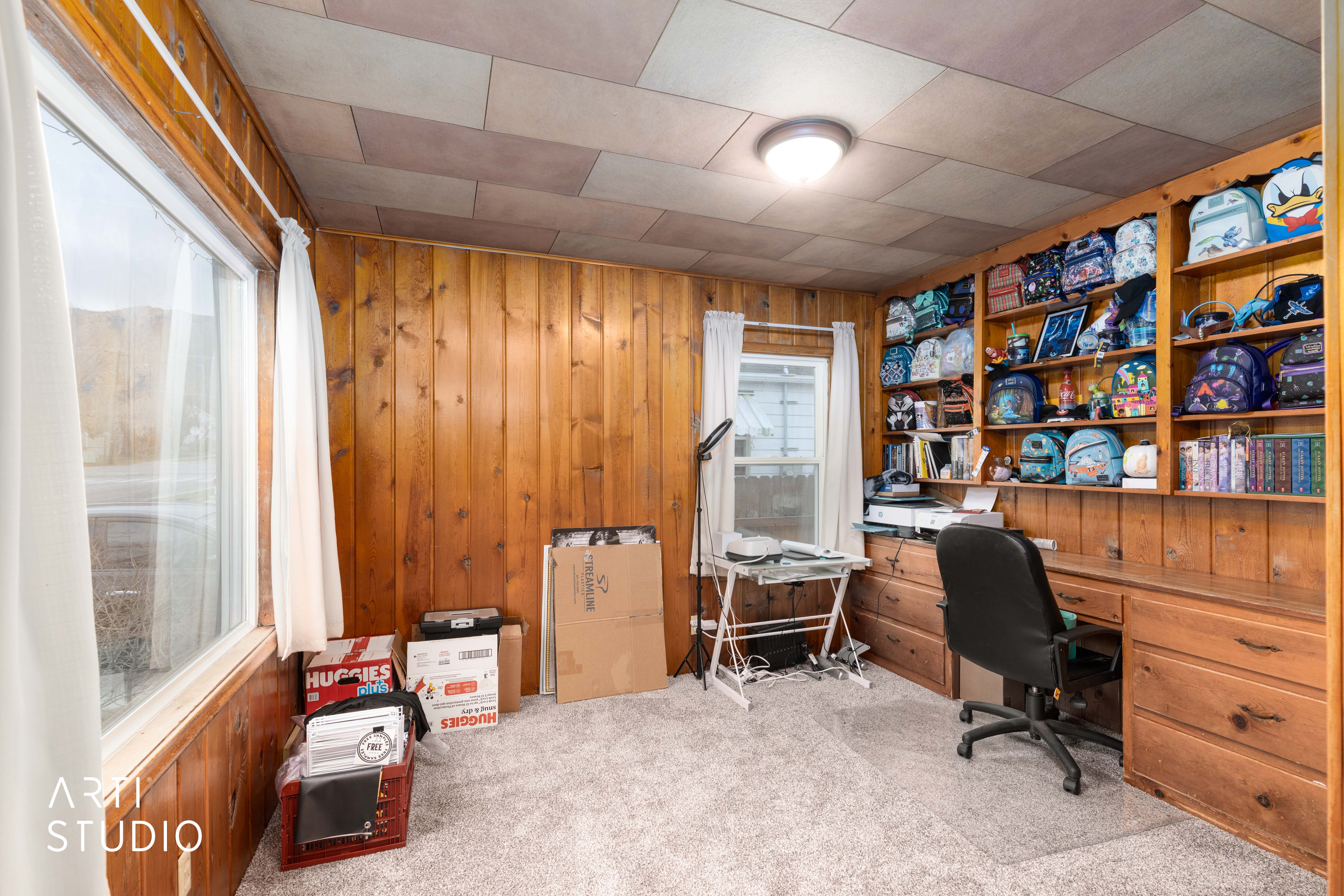 Office with wooden walls and light carpet