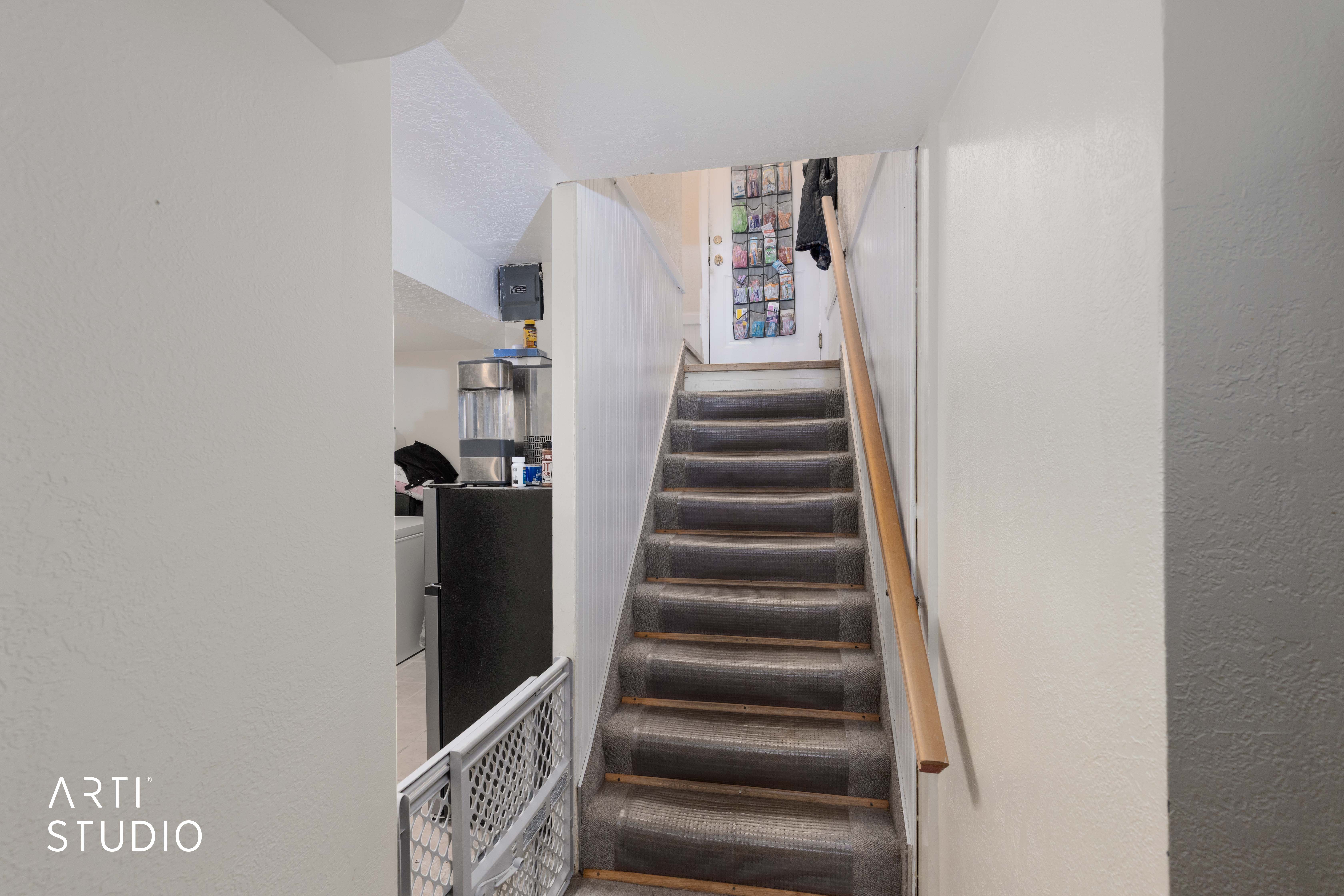 Staircase featuring a textured wall