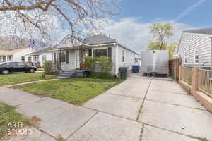 View of front of property with a gate and driveway