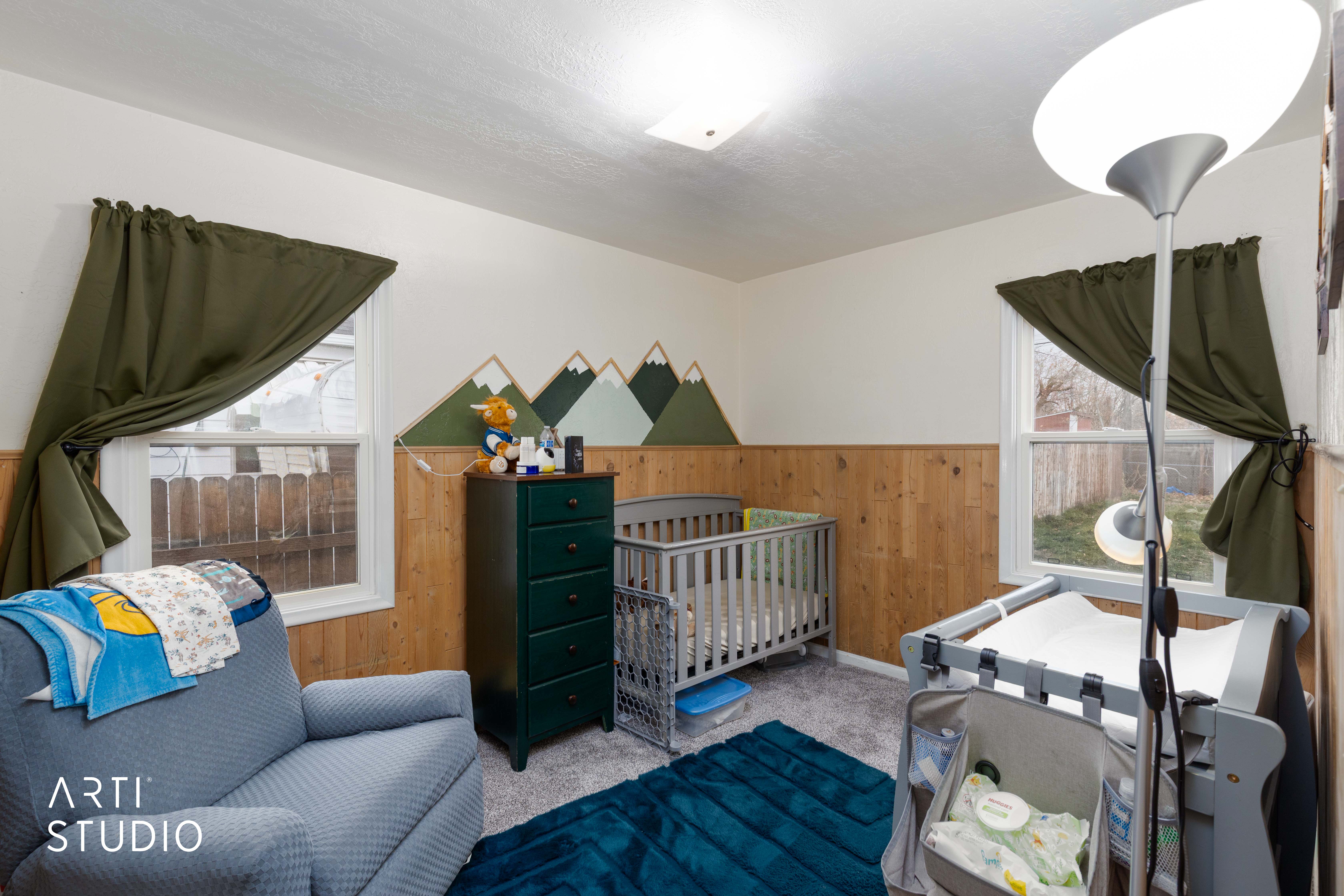 Bedroom featuring wooden walls, a wainscoted wall, and carpet