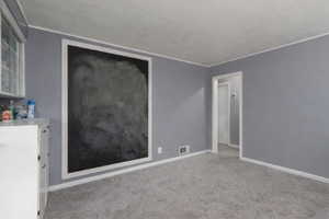 Unfurnished room with light carpet and crown molding
