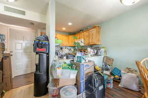 Kitchen featuring light wood-style floors, light countertops, recessed lighting, and light wood finish cabinets