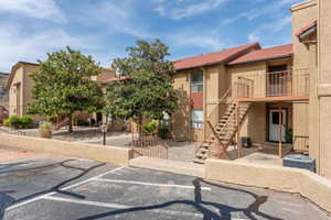 View of front facade with stucco siding and a tile roof