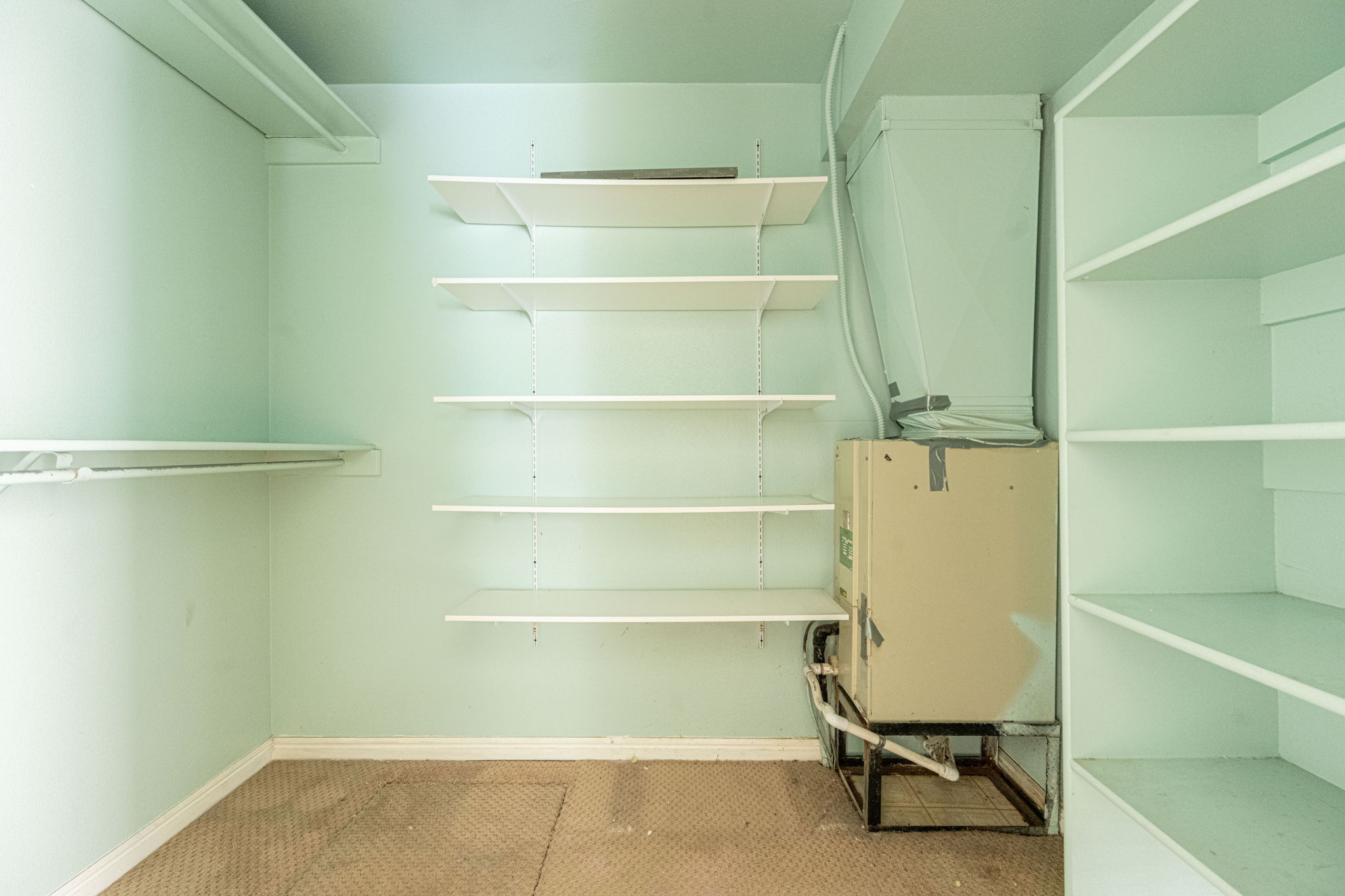 Interior utility space with adjustable shelving and built-in storage