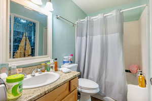 Full bath featuring vanity and shower / bath combination with curtain