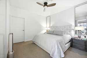 Bedroom featuring ceiling fan and light carpet
