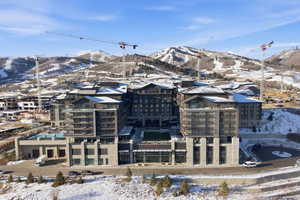 Snowy aerial view featuring a mountain view