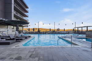 Community pool with a patio