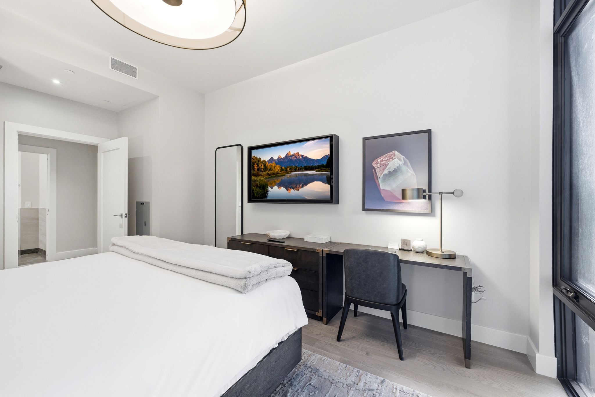 Bedroom with light wood-style flooring and baseboards