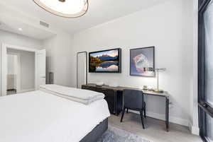 Bedroom with light wood-style flooring and baseboards