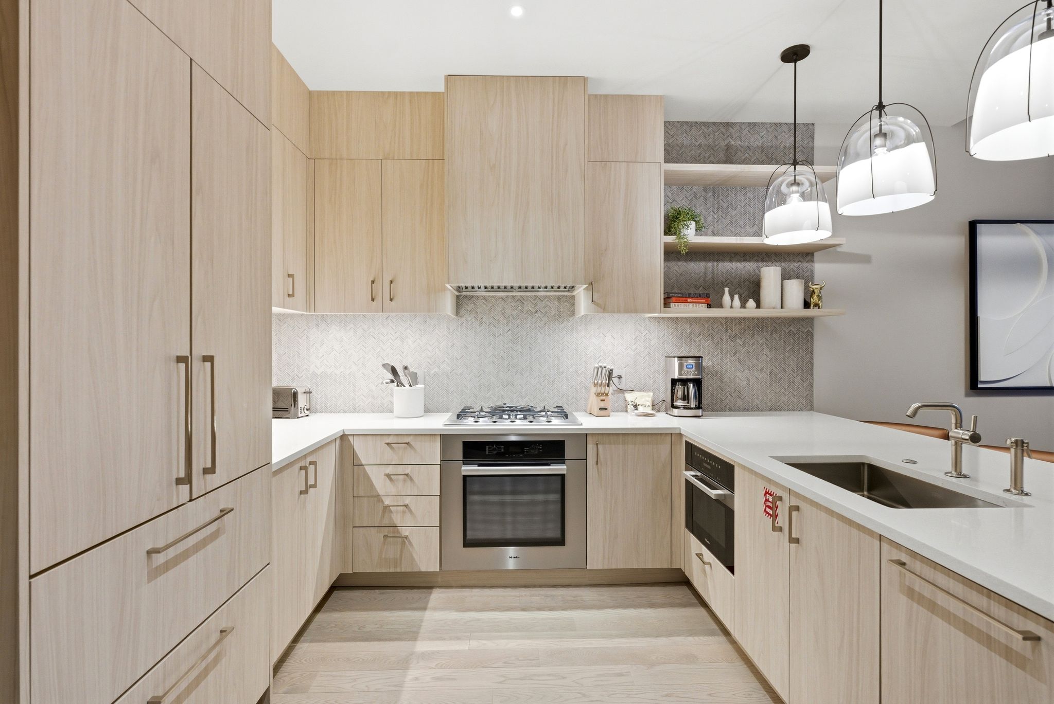 Kitchen with light wood finish cabinets, open shelves, stainless steel appliances, and decorative backsplash