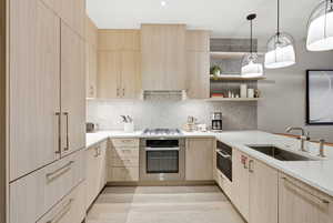 Kitchen with light wood finish cabinets, open shelves, stainless steel appliances, and decorative backsplash