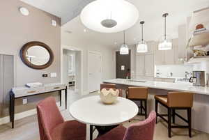Dining room with light wood-style flooring and a heating unit