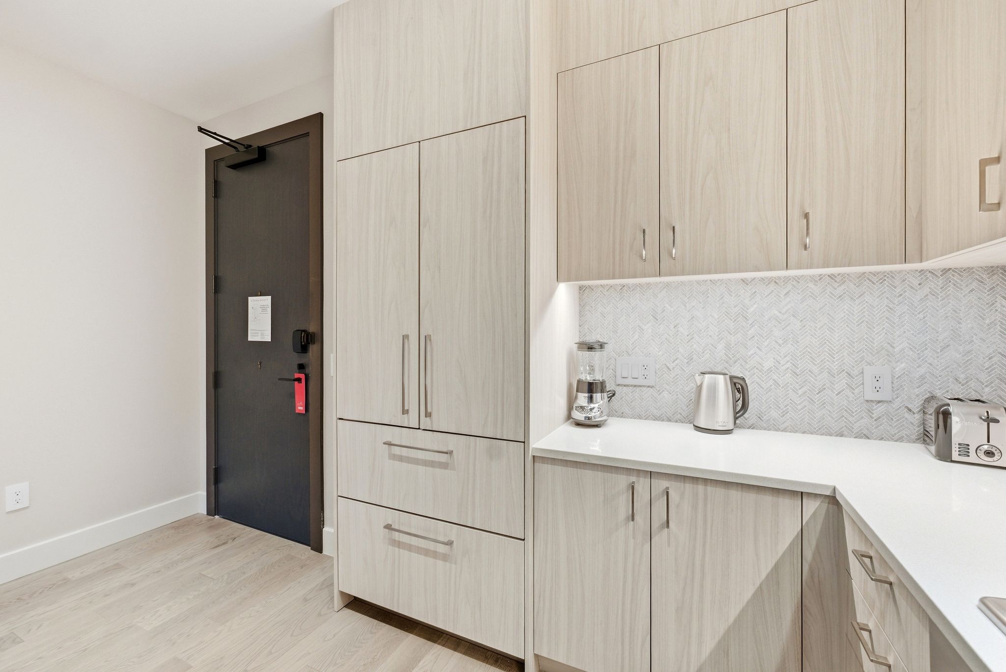 Kitchen featuring light wood finish cabinetry, modern cabinets, and light wood-style floors