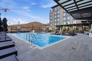 Community pool featuring a mountain view and a patio