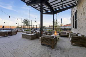 View of patio / terrace with an outdoor living space with a fire pit and a pergola