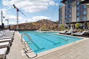Community pool featuring a patio and a mountain view