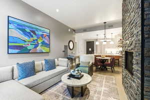 Living room featuring light wood-type flooring and a fireplace
