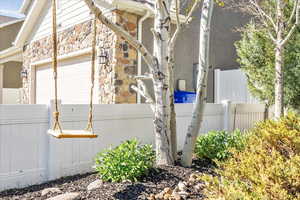 View of side of home with stone siding and stucco siding